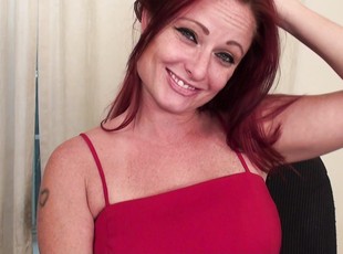 Redhead mature Sandi Lymm enjoys playing with her trimmed pussy